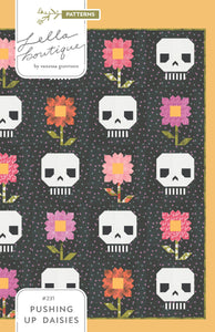 "Pushing Up Daisies" skull quilt by Lella Boutique. Cute mix of daisies and skeletons in this Halloween quilt. Fabric is Hey Boo by Lella Boutique for Moda Fabrics (April 2024). 
