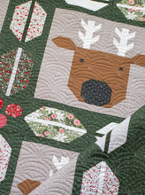 Load image into Gallery viewer, Christmas Crew - a holiday quilt featuring Santa and his reindeer framed in berry and pine sashing. Make it with a Jelly Roll or Layer Cake. Fabric is Berry & Pine by Lella Boutique for Moda Fabrics. Download the PDF here!