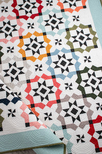 Glam Squad overlapping star tile quilt by Vanessa Goertzen of Lella Boutique. Fabric is Magic Dot by Lella Boutique for Moda Fabrics (October 2024). Make it with a dessert roll or fat eighths! Download the PDF pattern here.