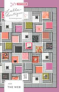 "The Web" modern Halloween quilt in Hey Boo fabric by Lella Boutique for Moda Fabrics. Modern spider web quilt using a Layer Cake and/or the Hey Boo quilt panel.