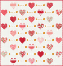 Load image into Gallery viewer, &quot;Playing Cupid&quot; valentines quilt featuring patchwork hearts and golden arrows. Make it with a Layer Cake or fat eighths. Fabric is Love Blooms by Lella Boutique for Moda Fabrics. (Nov 2024)