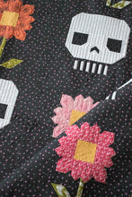 Load image into Gallery viewer, &quot;Pushing Up Daisies&quot; skull quilt by Lella Boutique. Cute mix of daisies and skeletons in this Halloween quilt. Fabric is Hey Boo by Lella Boutique for Moda Fabrics (April 2024). Download the PDF here!