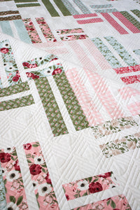 Stairway to Heaven jelly roll quilt by Vanessa Goertzen of Lella Boutique. Really cute geometric quilt in Lovestruck fabric by Lella Boutique for Moda Fabrics. Download the PDF here!