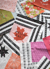Load image into Gallery viewer, "The Web" modern Halloween quilt in Hey Boo fabric by Lella Boutique for Moda Fabrics. Modern spider web quilt using a Layer Cake and/or the Hey Boo quilt panel.
