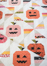 Load image into Gallery viewer, "Tricks & Treats" candy quilt featuring pumpkins and candy corn pinwheels. Fabric is Hey Boo by Lella Boutique for Moda Fabrics (April 2024).