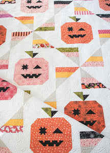 "Tricks & Treats" candy quilt featuring pumpkins and candy corn pinwheels. Fabric is Hey Boo by Lella Boutique for Moda Fabrics (April 2024).