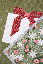 Load image into Gallery viewer, "Wrap It Up" gift quilt design by Vanessa Goertzen of Lella Boutique. Pretty wonky presents in a simple layout. Fat quarter friendly. Fabric is Berry & Pine by Lella Boutique for Moda Fabrics (May 2025). Download the PDF here.
