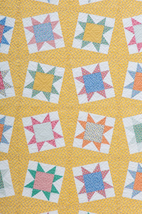 Tipsy sawtooth star quilt from the book: Charm School - 18 Quilts from 5" Squares by Vanessa Goertzen of Lella Boutique. Get your autographed copy of the book here! Lots of great charm pack quilts. Fabrics are from the Aunt Grace collections by Judie Rothermel for Marcus Fabrics.