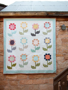 Cottage Blossoms flower quilt by Vanessa Goertzen of Lella Boutique. Make it with a layer cake or fat quarters. Fabric is Little Miss Sunshine by Lella Boutique for Moda Fabrics.