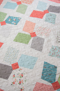 Easy Breezy large pinwheel quilt by Lella Boutique. Layer Cake friendly. Fabric is Nest by Lella Boutique for Moda Fabrics.