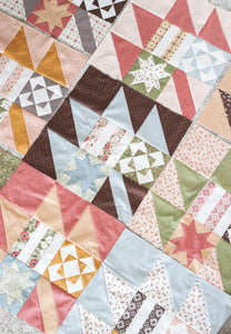 New Leaf scrappy leaf sampler quilt made with a Layer Cake. Fabric is Folktale by Lella Boutiquque for Moda Fabrics.