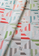 Load image into Gallery viewer, Parade scrappy pinwheel quilt from the book: Jelly Filled - 18 Quilts from 2-1/2" Strips by Vanessa Goertzen of Lella Boutique. Get your autographed copy of the book here! Lots of great jelly roll strip quilts. Fabric is Nest by Lella Boutique for Moda Fabrics.