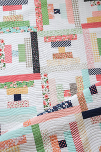 Parfait courthouse steps quilt from the book: Jelly Filled - 18 Quilts from 2-1/2" Strips by Vanessa Goertzen of Lella Boutique. Get your autographed copy of the book here! Lots of great jelly roll strip quilts. Fabric is Sugar Pie + Farmer's Daughter + Little Miss Sunshine by Lella Boutique for Moda Fabrics.