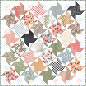 Twirl layer cake windmill quilt by Lella Boutique. Make it with a layer cake and charm packs, fat quarters, or fat eighths. Fabric is Country Rose by Lella Boutique for Moda Fabrics.