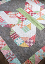 Load image into Gallery viewer, Butterfly Patch - scrappy patchwork butterfly quilt by Lella Boutique. Beginner level sampler made with a Layer Cake (precut 10&quot; squares). Fabric is Lollipop Garden by Lella Boutique for Moda Fabrics. Background is Grey Couture Grunge by BasicGrey. Double the sampler blocks for a scrappy patchwork border.