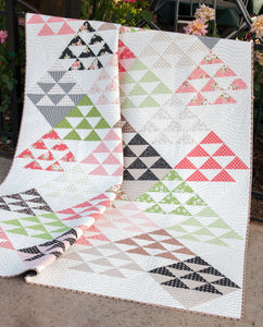 Homestead triangle quilt by Vanessa Goertzen of Lella Boutique. Layer Cake friendly. Fabric is Olive's Flower Market by Lella Boutique for Moda Fabrics.