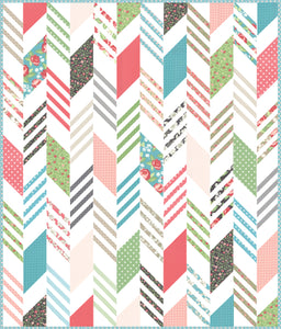Modern Herringbone quilt by Lella Boutique. Make it with a Honeybun (1.5" strips) and fat quarters. Fabric is Bloomington by Lella Boutique for Moda Fabrics. Download the PDF here!