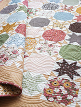 Load image into Gallery viewer, Starstruck 2 bursting star quilt featuring sawtooth star blocks. Layer Cake quilt or fat quarter quilt. Fabric is Folktale by Lella Boutique for Moda. Download the PDF here!