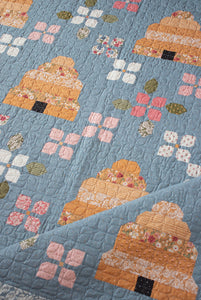Bloom & Buzz beehive and flower quilt by Lella Boutique. Jelly Roll friendly Fabric is Wild Honey by Lella Boutique for Moda Fabrics (Nov 2025).