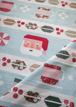 Load image into Gallery viewer, "Cocoa Party" Christmas row quilt featuring patchwork Santa, peppermint swirls, cocoa mugs, marshmallows, and holly and berry sashing. This Christmas sampler quilt is made with fat eighths of Peppermint Cocoa fabric by Lella Boutique for Moda Fabrics. Download the PDF here!