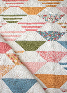 "Honey Glow" easy hexagon quilt by Lella Boutique. Make it with a Honeybun + fat quarters. Fabric is Wild Honey by Lella Boutique for Moda Fabrics (Nov 2025).