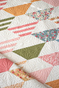 "Honey Glow" easy hexagon quilt by Lella Boutique. Make it with a Honeybun + fat quarters. Fabric is Wild Honey by Lella Boutique for Moda Fabrics (Nov 2025).