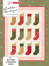 Load image into Gallery viewer, "By the Chimney Mini" Christmas stocking wall hanging quilt pattern in Peppermint Cocoa by Lella Boutique for Moda Fabrics. Perfect for scraps! Download the PDF here!
