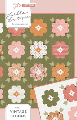 Vintage Blooms flower quilt in Wild Honey fabric by Lella Boutique for Moda Fabrics. Beautiful patchwork blooms of gold, white, and pinks set against a rich, green background. Fat quarter friendly. Download the PDF here.