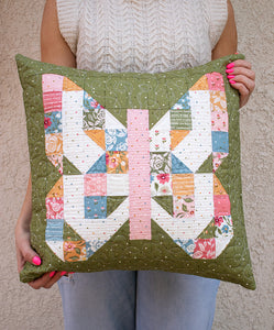 Mini Charmed butterfly pillow. Make this scrappy butterfly block with a mini charm pack. Fabric is Wild Honey by Lella Boutique for Moda Fabrics (Nov 2025).