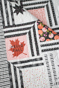 "The Web" modern Halloween quilt in Hey Boo fabric by Lella Boutique for Moda Fabrics. Modern spider web quilt using a Layer Cake and/or the Hey Boo quilt panel. Download the PDF pattern here!