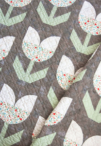 "Holland" tulip quilt by Lella Boutique. Beginner curved piecing to make simple tulip blocks. Fabric is Garden Variety by Lella Boutique for Moda Fabrics.