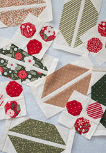 Load image into Gallery viewer, "Cocoa Party" Christmas row quilt featuring patchwork Santa, peppermint swirls, cocoa mugs, marshmallows, and holly and berry sashing. This Christmas sampler quilt is made with fat eighths of Peppermint Cocoa fabric by Lella Boutique for Moda Fabrics. Download the PDF here!