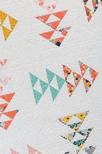 Up Ahead modern triangle quilt from the book: Charm School - 18 Quilts from 5" Squares by Vanessa Goertzen of Lella Boutique. Get your autographed copy of the book here! Lots of great charm pack quilts. Fabric is Fancy & Fabulous from Fancy Pants Designs for Riley Blake.