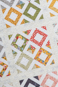 Hoodwink easy diamond quilt from the book: Charm School - 18 Quilts from 5" Squares by Vanessa Goertzen of Lella Boutique. Get your autographed copy of the book here! Lots of great charm pack quilts. Fabric is Mon Ami by BasicGrey for Moda Fabrics.