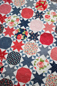 Starstruck 2 beautiful bursting star quilt featuring sawtooth stars. Fat quarter quilt or layer cake quilt. Fabric is Early Bird by Bonnie & Camille for Moda Fabrics. Makes a great 4th of July quilt!