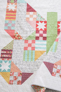 Butterfly Patch - scrappy patchwork butterfly quilt by Lella Boutique. Beginner level sampler made with a Layer Cake (precut 10" squares). Fabric is Lollipop Garden by Lella Boutique for Moda Fabrics.