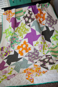 Twirl pinwheel layer cake quilt using Heather Bailey fabric