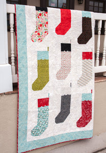 By the Chimney Christmas stocking quilt by Lella Boutique. Fabric is Juniper Berry by BasicGrey for Moda Fabrics.