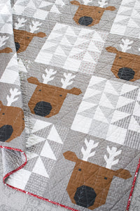 Reindeer Xing pieced reindeer quilt by Vanessa Goertzen of Lella Boutique. Fabric is Christmas Eve by Lella Boutique for Moda Fabrics. Make it with fat quarters or scrappy with a Layer Cake.