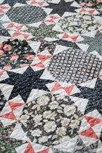 Load image into Gallery viewer, Starstruck 2 bursting star quilt featuring sawtooth star blocks. Layer Cake quilt or fat quarter quilt. Fabric is a scrappy assortment of charcoal prints by Lella Boutique for Moda. Great farmhouse quilt. Download the PDF here!