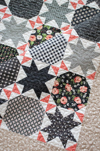 Starstruck 2 beautiful bursting star quilt featuring sawtooth stars. Fat quarter quilt or layer cake quilt. Fabric is scrappy charcoal prints by Lella Boutique for Moda Fabrics. Great farmhouse quilt