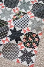 Load image into Gallery viewer, Starstruck 2 bursting star quilt featuring sawtooth star blocks. Layer Cake quilt or fat quarter quilt. Fabric is a scrappy assortment of charcoal prints by Lella Boutique for Moda. Great farmhouse quilt. Download the PDF here!