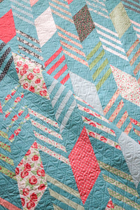 Modern Herringbone quilt by Lella Boutique. Make it with a Honeybun (1.5" strips) and fat quarters. Fabric is Bloomington by Lella Boutique for Moda Fabrics. Download the PDF here!