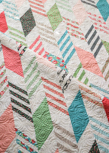 Modern Herringbone quilt by Lella Boutique. Make it with a Honeybun (1.5" strips) and fat quarters. Fabric is Bloomington by Lella Boutique for Moda Fabrics.