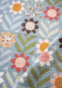 "Spring Fling" geometric flower quilt by Lella Boutique. Fat quarter quilt. Fabric is Folktale by Lella Boutique for Moda Fabrics. Download the PDF here!