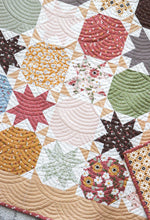 Load image into Gallery viewer, Starstruck 2 bursting star quilt featuring sawtooth star blocks. Layer Cake quilt or fat quarter quilt. Fabric is Folktale by Lella Boutique for Moda. Download the PDF here!